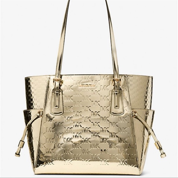 Michael Kors Handbags - MICHAEL KORS Voyager Large Metallic Logo Debossed EW Shoulder Tote Bag
Pale Gold